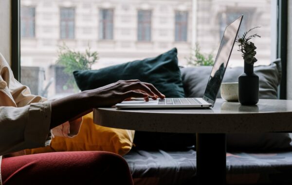 Hands typing on a laptop